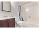 Well-lit bathroom features a shower and tub, a white toilet, and a vanity with modern fixtures at 6131 Wolff St, Arvada, CO 80003