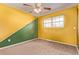 Colorful bedroom with unique yellow and green wall and window with natural light at 6131 Wolff St, Arvada, CO 80003