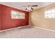 Bright bedroom featuring plush carpeting, a ceiling fan, and two windows for natural light at 6131 Wolff St, Arvada, CO 80003