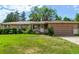 Inviting single-story home with a well-maintained lawn, lovely landscaping, and an attached garage at 6131 Wolff St, Arvada, CO 80003