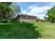 Charming home exterior with a green lawn, white brick foundation, and a privacy fence for added seclusion at 6131 Wolff St, Arvada, CO 80003