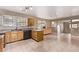 Sunlit kitchen with wood cabinetry, updated countertops, and stainless steel appliances at 6131 Wolff St, Arvada, CO 80003