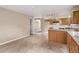 Open kitchen with linoleum floors and plentiful wood cabinetry for storage at 6131 Wolff St, Arvada, CO 80003