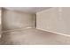 Spacious carpeted living room features neutral paint, base trim, and many windows at 6131 Wolff St, Arvada, CO 80003