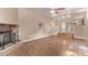 Living room featuring wood flooring, stone fireplace, and open floorplan at 6131 Wolff St, Arvada, CO 80003