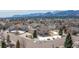 Aerial view of a two-story home in a neighborhood with mountain views and a snowy lawn at 15640 Agate Creek Dr, Monument, CO 80132