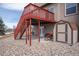 Backyard patio with outdoor staircase leading to a second story deck and a storage shed at 15640 Agate Creek Dr, Monument, CO 80132