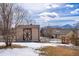 Backyard shed, fence, and snow capped mountain views create a stunning Colorado outdoor space at 15640 Agate Creek Dr, Monument, CO 80132