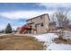 Two-story home with a charming backyard, a red deck, storage shed, and lush greenery at 15640 Agate Creek Dr, Monument, CO 80132