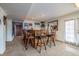 A relaxed bar area featuring a wooden bar, stools, decorative mirrors, and access to an exterior door at 15640 Agate Creek Dr, Monument, CO 80132