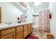 Bathroom with a double vanity, a skylight, and a shower-tub combination that maximizes functionality and comfort at 15640 Agate Creek Dr, Monument, CO 80132