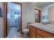 Clean bathroom with essential fixtures including a vanity, toilet, and a door to the laundry room at 15640 Agate Creek Dr, Monument, CO 80132