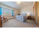 Serene bedroom with a cozy window seat, soft blue accents, and plenty of natural light for relaxation and comfort at 15640 Agate Creek Dr, Monument, CO 80132