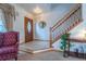Bright foyer with tiled flooring, staircase, and a traditional wooden door at 15640 Agate Creek Dr, Monument, CO 80132