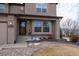 Charming home entrance featuring a decorative wreath, landscaped garden, and well-maintained lawn at 15640 Agate Creek Dr, Monument, CO 80132