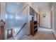 Welcoming hallway with a charming staircase and natural light that creates an inviting transition between spaces at 15640 Agate Creek Dr, Monument, CO 80132