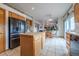 Open concept kitchen with a center island, breakfast bar, and modern appliances, perfect for Gathering living at 15640 Agate Creek Dr, Monument, CO 80132