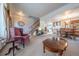 Cozy living room with a staircase, dining area, and a warm, inviting atmosphere at 15640 Agate Creek Dr, Monument, CO 80132
