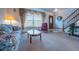 Comfortable living room featuring a large window, floral sofa, and traditional decor at 15640 Agate Creek Dr, Monument, CO 80132