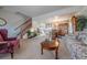 Spacious living room with a staircase, dining area, and ample natural light at 15640 Agate Creek Dr, Monument, CO 80132