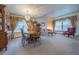 Inviting living area with hardwood flooring, large windows, and classic neutral-toned curtains at 15640 Agate Creek Dr, Monument, CO 80132