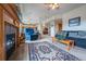 Open-concept living room with a fireplace and seamless transition to the kitchen and dining areas at 15640 Agate Creek Dr, Monument, CO 80132