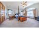 Bright main bedroom featuring a vaulted ceiling, a canopy bed, and large windows, creating an open, airy feel at 15640 Agate Creek Dr, Monument, CO 80132