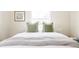 A close up of a well decorated bedroom featuring white linens and green pillows on a large bed at 2773 S Franklin St, Denver, CO 80210