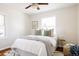 Bedroom features a large bed, wood floors, and a window with ample natural light at 2773 S Franklin St, Denver, CO 80210