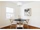 Charming dining area with hardwood floors, a modern light fixture, and a round table at 2773 S Franklin St, Denver, CO 80210