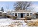 Charming blue house featuring a well-maintained front yard and a convenient attached carport at 2773 S Franklin St, Denver, CO 80210