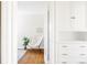 Bright hallway featuring hardwood floors, a butterfly chair and a modern storage unit at 2773 S Franklin St, Denver, CO 80210