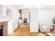 An open-concept kitchen and living area with wood floors and a brick accent wall at 2773 S Franklin St, Denver, CO 80210