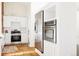 This kitchen features stainless steel appliances, bright white cabinetry and wood floors at 2773 S Franklin St, Denver, CO 80210