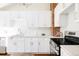 Stylish kitchen featuring white cabinetry, modern appliances, and a subway tile backsplash at 2773 S Franklin St, Denver, CO 80210