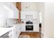 Bright kitchen features white cabinetry, subway tile backsplash, stainless appliances, and exposed brick at 2773 S Franklin St, Denver, CO 80210