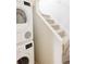 Laundry area features a stacked washer and dryer next to a carpeted staircase at 2773 S Franklin St, Denver, CO 80210