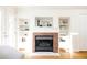 This living room features a brick fireplace, built-in shelves, and hardwood floors at 2773 S Franklin St, Denver, CO 80210