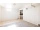 Bright living room with carpeted floor and an adjacent kitchenette, with white walls at 2773 S Franklin St, Denver, CO 80210