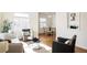 Bright living room with hardwood floors, modern furniture, and large windows filling the space with natural light at 2773 S Franklin St, Denver, CO 80210