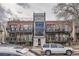 Brick condo building with metal stairwells and balconies with on-street parking at 1045 N Clarkson St # 105, Denver, CO 80218