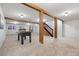 Large basement featuring light carpet, fireplace, foosball table, and wooden supports at 7883 S Espana Way, Centennial, CO 80016