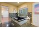 A luxurious bathroom features a deep soaking tub, neutral walls, granite tile and a window with an outdoor view at 7883 S Espana Way, Centennial, CO 80016