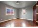Bedroom features hardwood floors, two windows, and light gray walls at 7883 S Espana Way, Centennial, CO 80016