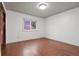 Bright, empty bedroom featuring hardwood floors and a view from the window at 7883 S Espana Way, Centennial, CO 80016