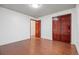 Bedroom with hardwood floors, white trim, and wooden closet doors at 7883 S Espana Way, Centennial, CO 80016