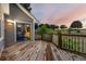 Back deck boasts wood railing and lush greenery overlooking a scenic yard at 7883 S Espana Way, Centennial, CO 80016