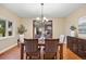 This dining room features modern decor and an adjacent living room space at 7883 S Espana Way, Centennial, CO 80016