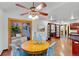 The dining room has a ceiling fan, an adjacent living room, and an outdoor deck at 7883 S Espana Way, Centennial, CO 80016