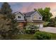 Two-story home with attached three car garage, with brick and siding and a well maintained yard at 7883 S Espana Way, Centennial, CO 80016